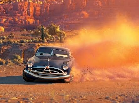 a car driving through the desert with dust coming out of it