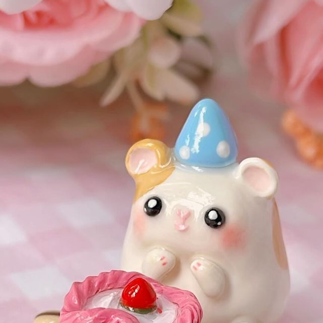 a white bear figurine holding a pink heart