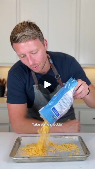 a man in an apron is making pasta