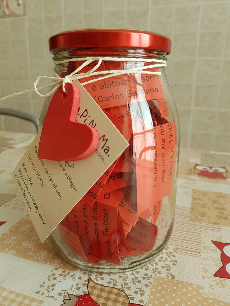 a jar filled with lots of red paper hearts