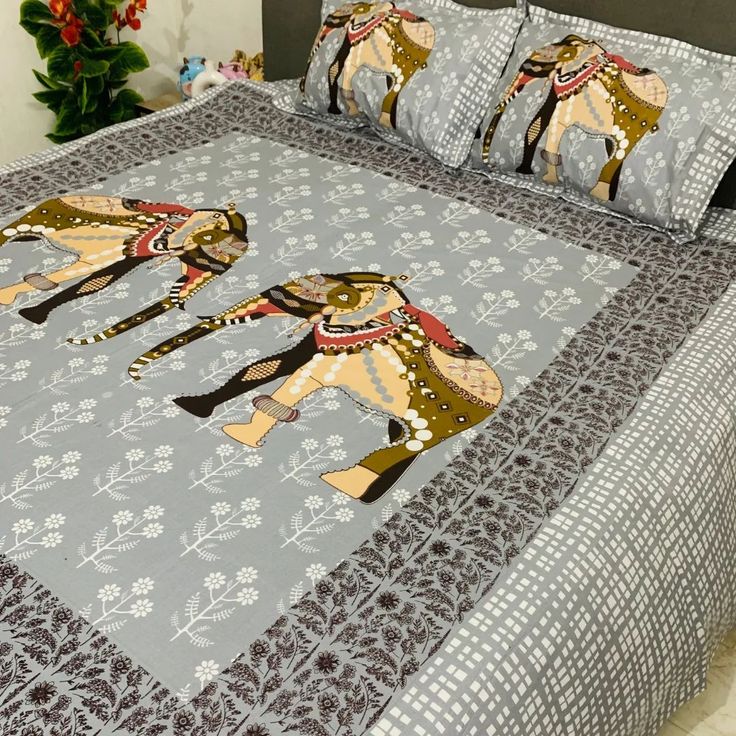 a bed with two elephants on it and some flowers in the room behind it,