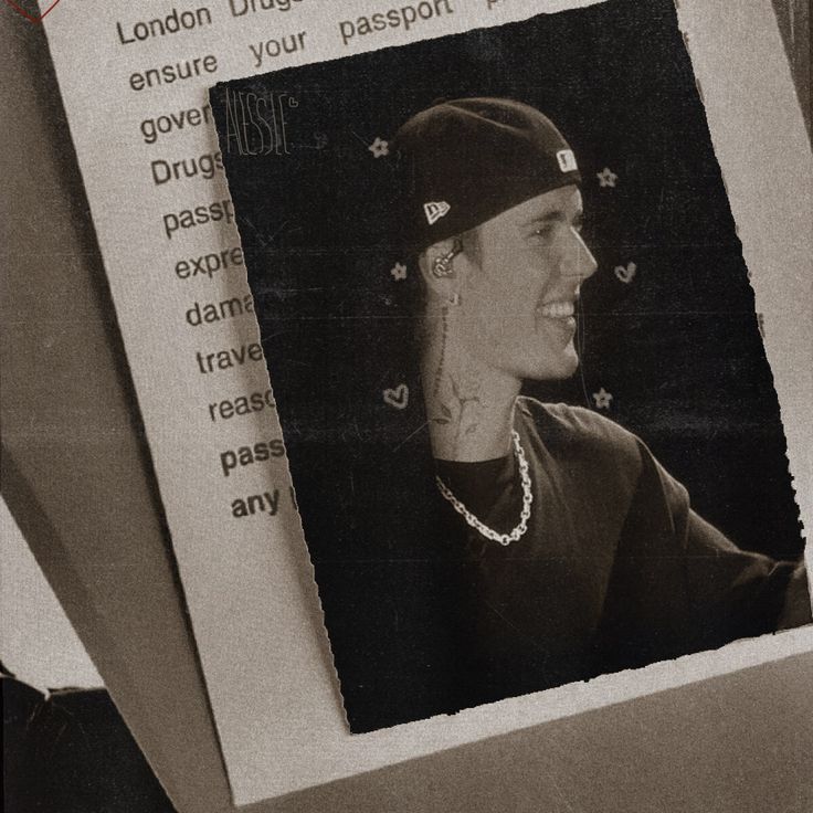 a black and white photo of a woman wearing a hat with words written on it