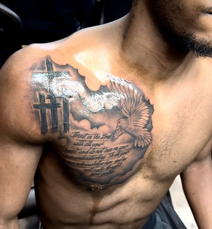 a man with a cross and dove tattoo on his chest