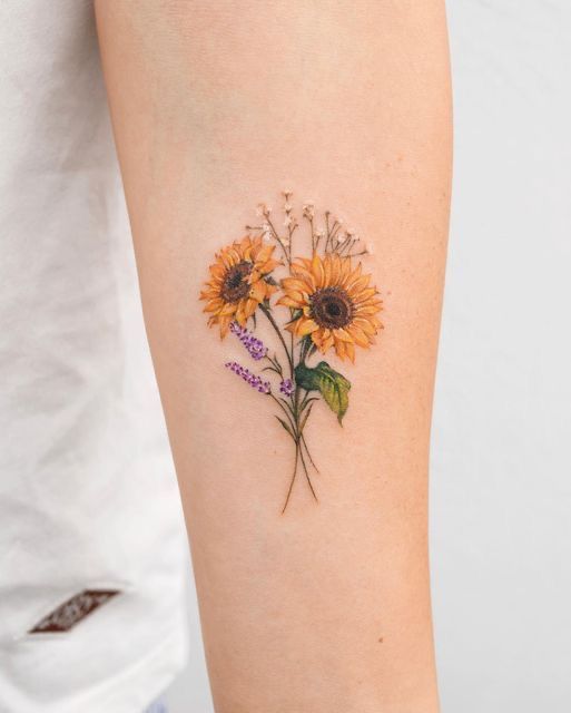 a sunflower tattoo on the left arm