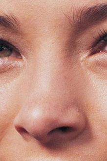 a close up of a woman's face with brown eyes