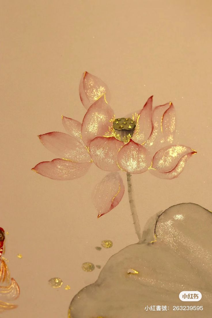 a pink flower floating on top of a body of water next to a buddha statue