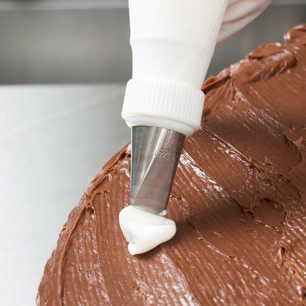 a person is spreading frosting on a cake