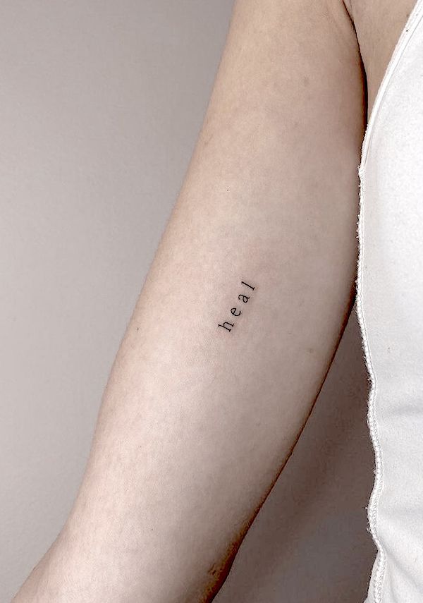 a woman's arm with the word love tattooed on her left arm, in cursive font