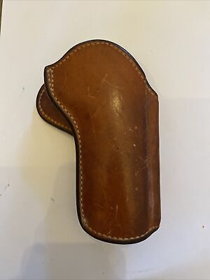 an old brown leather case with stitching on the inside and outside, sitting on a white surface