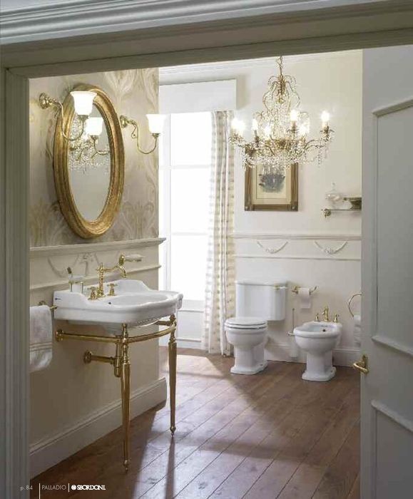 an open door leading to a bathroom with chandelier