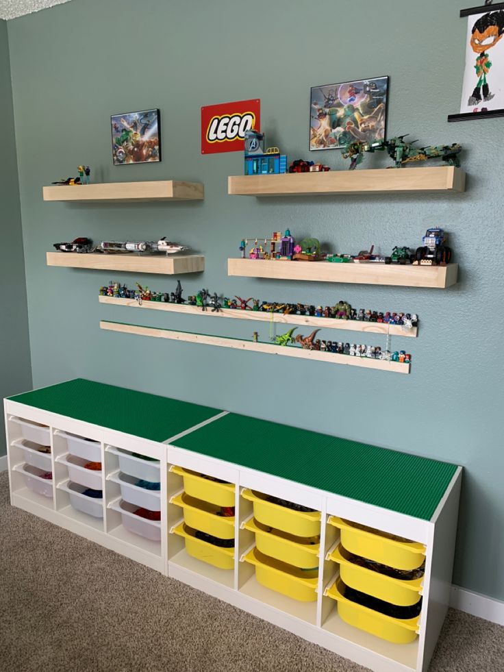 a lego room with shelves and bins on the wall, toy storage boxes below