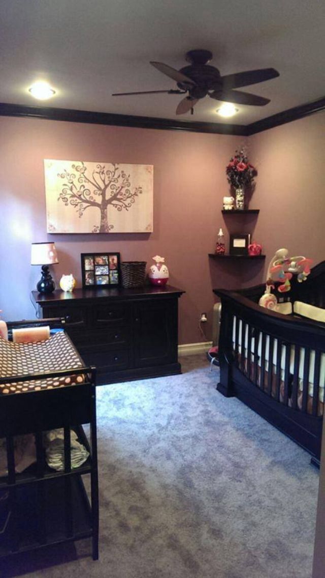 a baby's room is decorated in purple and black with lots of decor on the walls