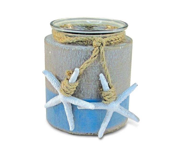 a candle holder with two starfishs tied to the top and rope around it