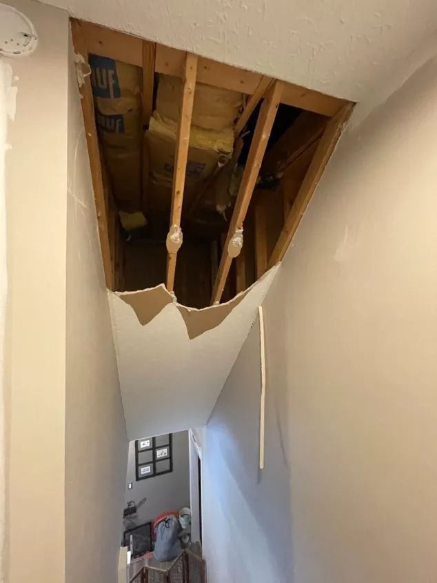 an unfinished room with exposed rafters and wood flooring on the ceiling is shown