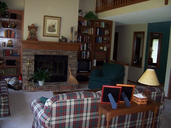 a living room filled with furniture and a fire place