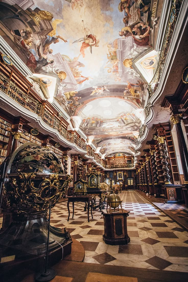 an ornate library with many bookshelves and paintings on the ceiling