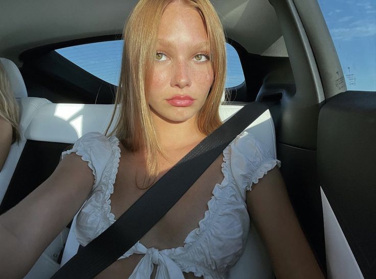 a woman sitting in the back seat of a car