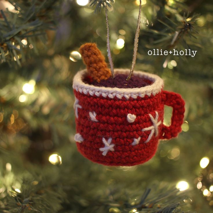 a crocheted coffee cup ornament hanging from a christmas tree