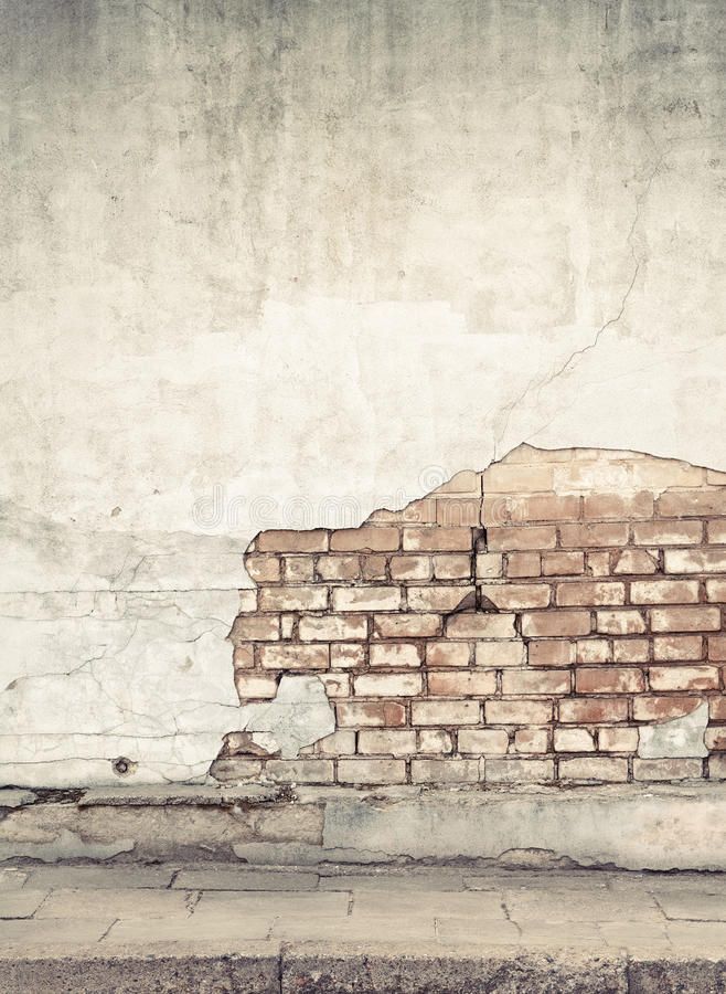 an old brick wall that has been torn down and is being used as a background