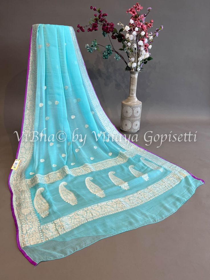 Sky blue and Purple Banarasi Chiffon Silk Saree and Blouse. Capture the captivating beauty of the season with this exclusive Sky blue and Purple Banarasi Chiffon Silk Saree and Blouse. This intricate garment is sure to make a statement of sophistication and luxury. Perfect for special occasions or everyday, add this piece to your wardrobe and experience the elegance and beauty of the highest quality. Elegant Blue Georgette Traditional Wear, Designer Chikankari Embroidered Chiffon Dupatta, Traditional Silk Chiffon Saree For Festive Occasions, Festive Traditional Silk Chiffon Saree, Festive Light Blue Saree With Sheer Dupatta, Light Blue Chikankari Embroidered Georgette Dupatta, Blue Saree With Chikankari Embroidery, Blue Silk Traditional Wear With Chikankari Embroidery, Blue Blouse Piece With Chikankari Embroidery For Festive