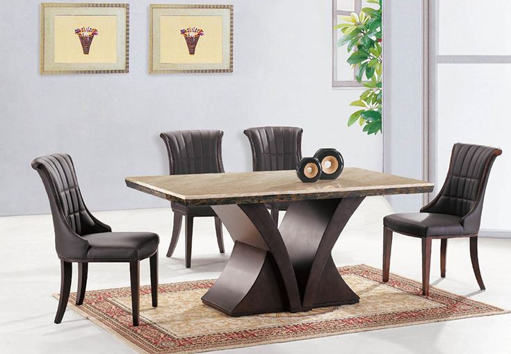 a dining table with chairs around it and a rug on the floor in front of it