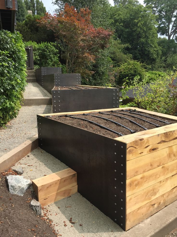 an outdoor bed made out of metal and wood with steps leading up to the top