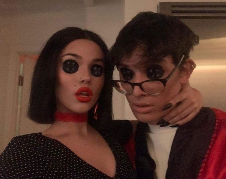 a man and woman with fake eyes posing for the camera