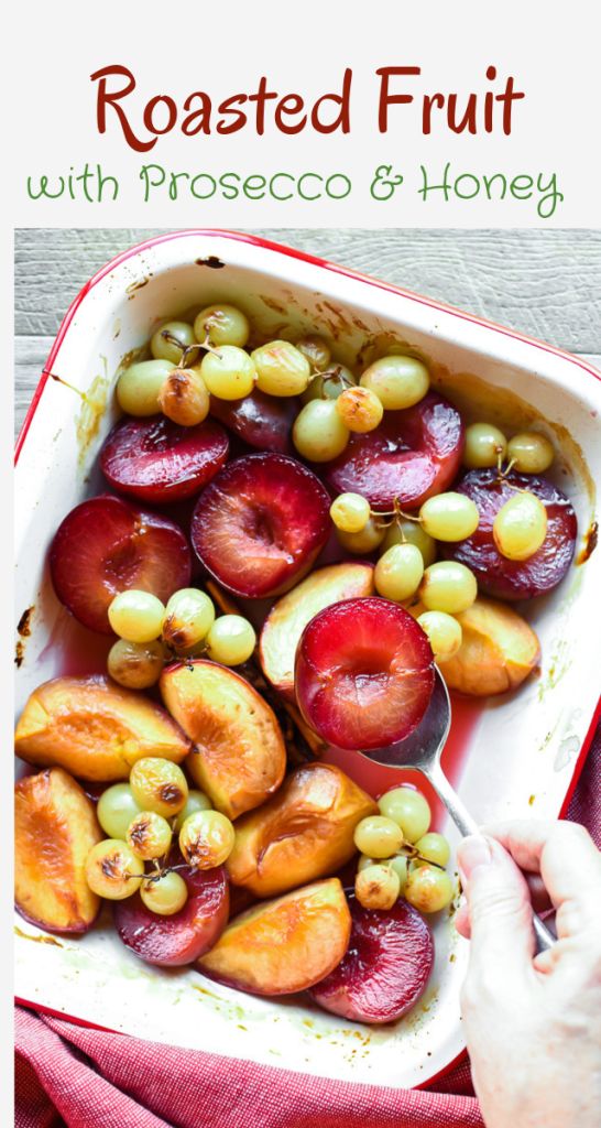 roasted fruit with prosceco and honey in a casserole dish on a red cloth