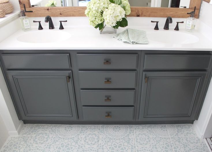 a bathroom with two sinks and a large mirror