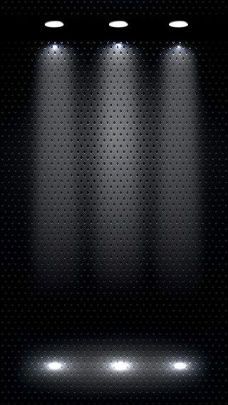 three spotlights are lit up on a black background with dots in the center and below them