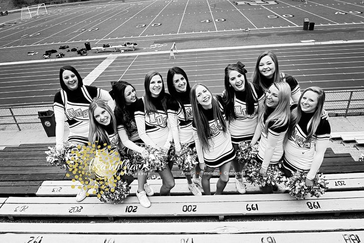 black and white photograph of cheerleaders on bleachers