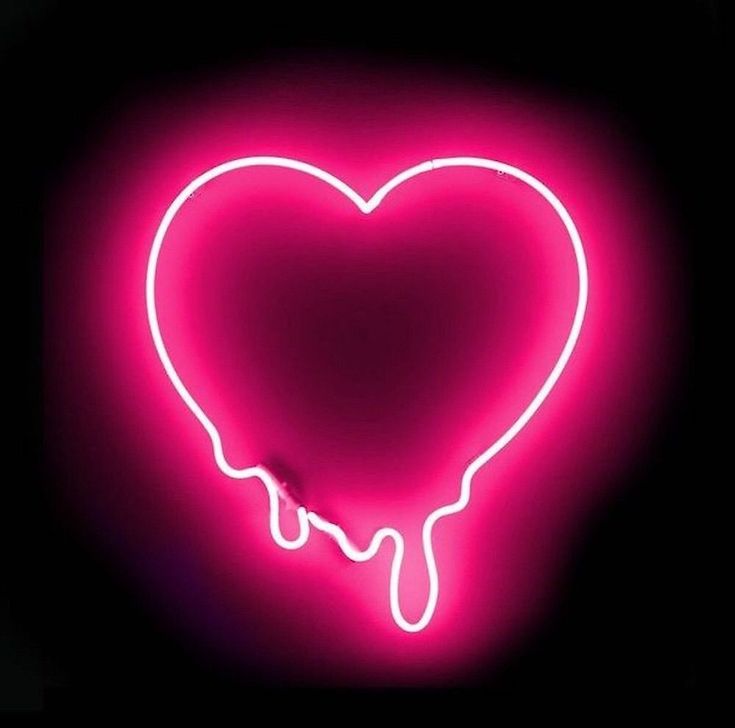 a neon heart with dripping liquid in the middle