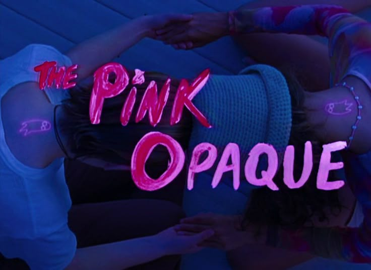 the pink opaeque logo with two girls in front of it and one girl holding her head