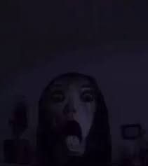 a woman with her mouth open in the dark