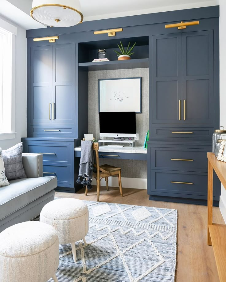 a living room filled with furniture and a flat screen tv on top of a desk