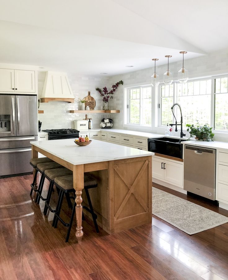 a large kitchen with an island in the middle