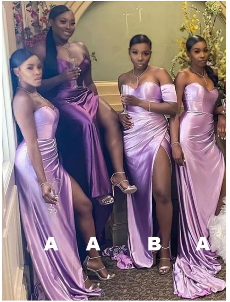 four women in purple dresses posing for the camera