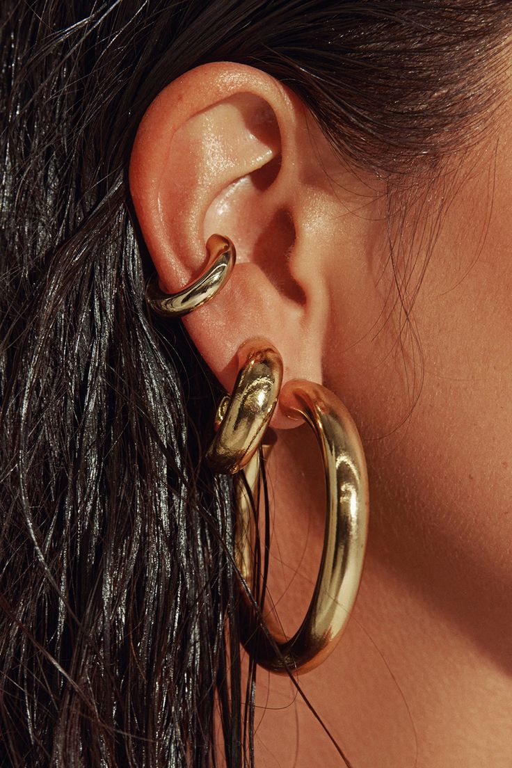 Any outfit, every day, all occasions. Sculpted in a two-inch arc, our 18K gold filled hoops are the style that unites true hoop girls and those who just dabble in the art. Wear solo or alongside other hoops in a graduating stack. Jewelry Collection Handcrafted in Brazil 18k Gold Filled Thickness: 7mm Diameter: 2" Weight: 0.55 oz Waterproof Hypoallergenic Gold Hoop Earring Stack, Stack Jewelry, Chunky Gold Earrings, Gold Statement Jewelry, Chunky Gold Jewelry, Thick Gold Hoop Earrings, Thick Gold Hoops, Dope Jewelry Accessories, Xmas Wishlist