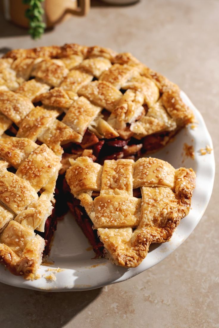 a pie on a plate with one slice cut out and ready to be eaten by someone