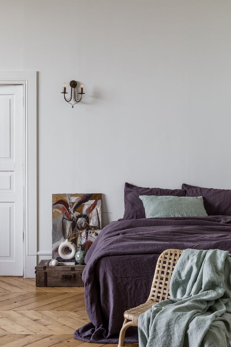 a bed sitting in a bedroom next to a wooden floor