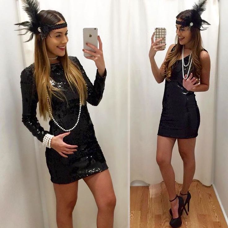 a woman in a black dress is taking a selfie with her cell phone and wearing a feather headband