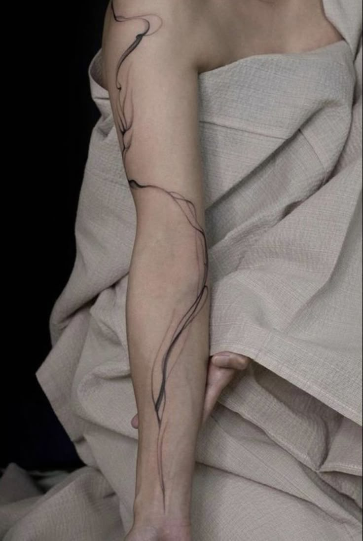 a woman with a tattoo on her arm