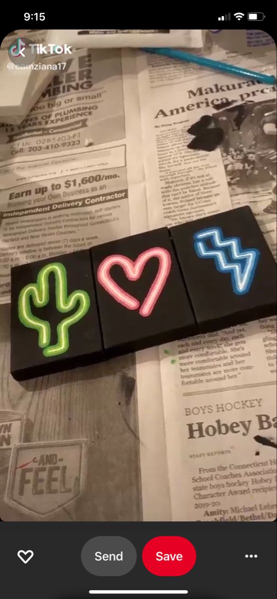 some kind of neon sticker that is laying on top of newspaper paper with the word love