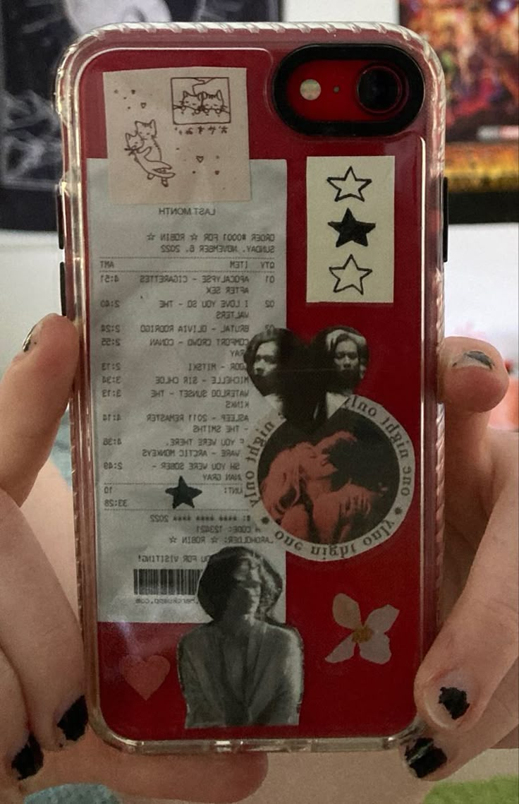 a person holding up a cell phone case with stickers on it's side