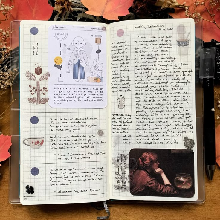 an open notebook with pictures and writing on it next to autumn leaves, scissors and other items