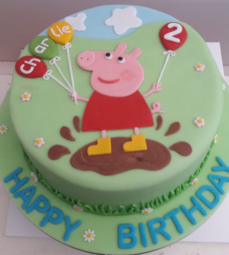 a green birthday cake with a peppa pig on it