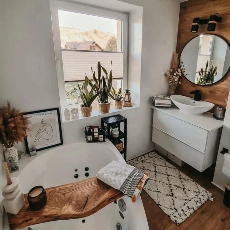 a bathroom with a white bathtub and wooden counter top in front of a window