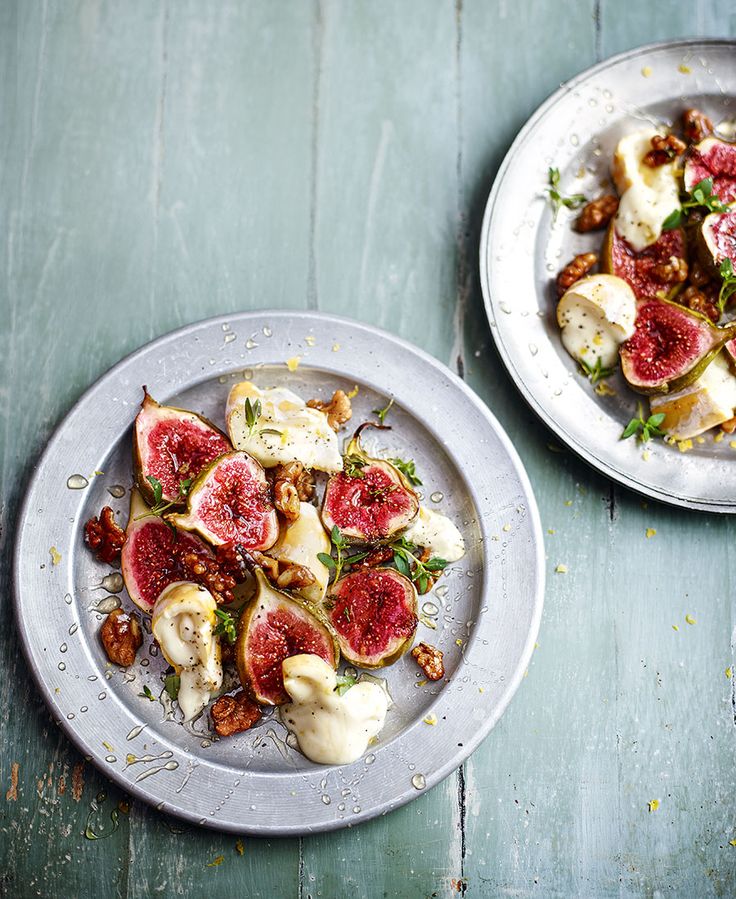 two plates filled with food on top of a wooden table