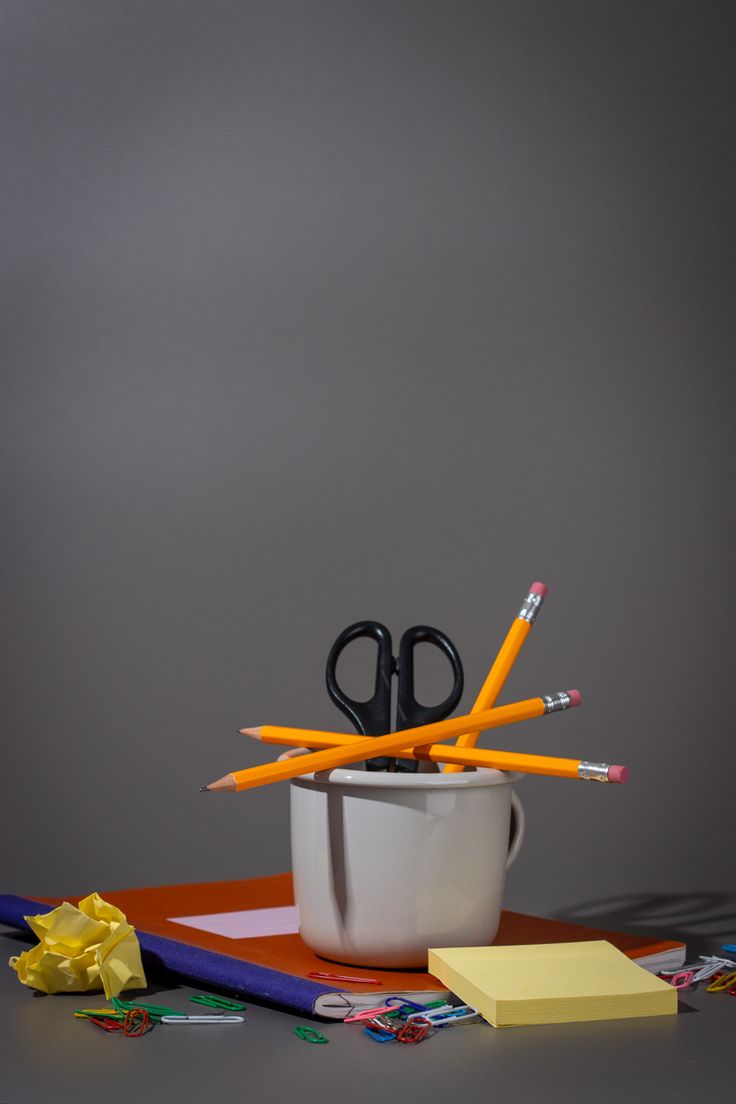 a cup with scissors and pencils in it