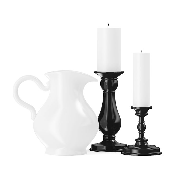 a white pitcher and two black candles